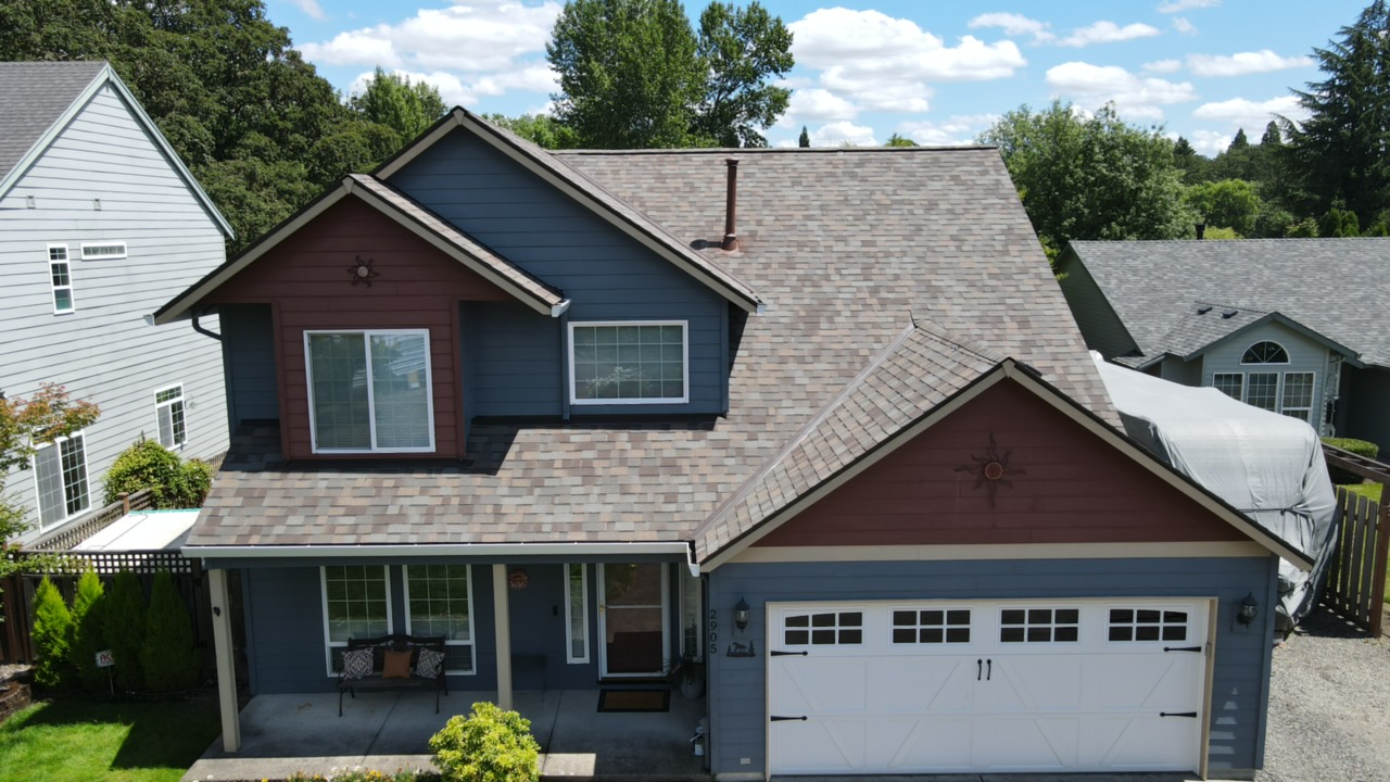 Completed roof replacement, two-story home with brick accents, Hillsboro