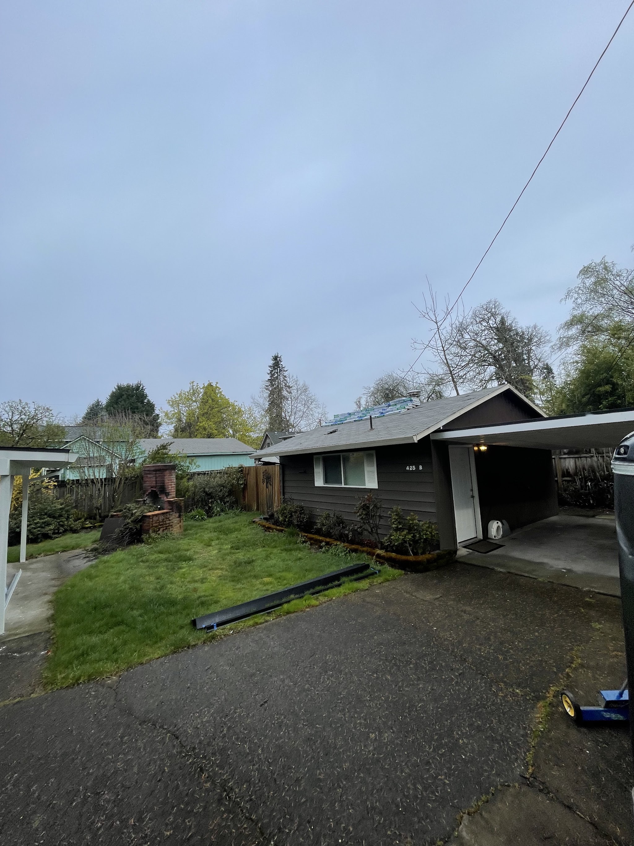 Roofing materials staged mid-job during a shingle replacement