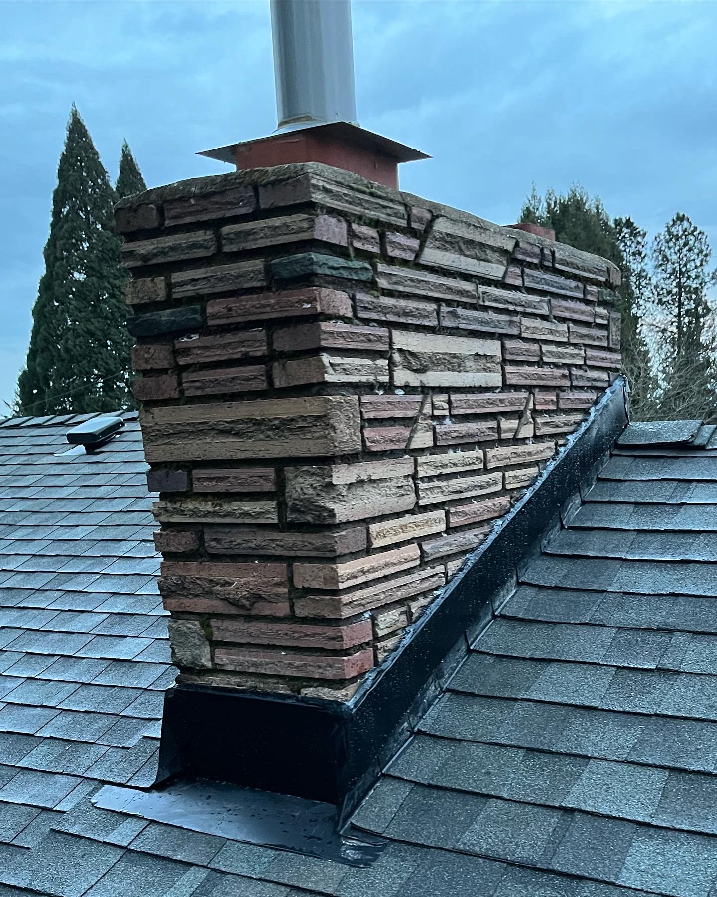 Aerial view of a completed shingle roof replacement, front elevation