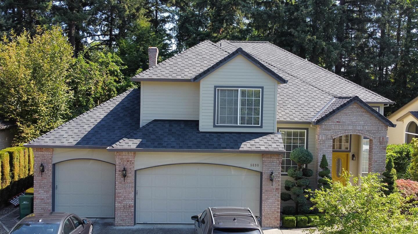 Aerial view of a completed roof replacement, two-story brick home