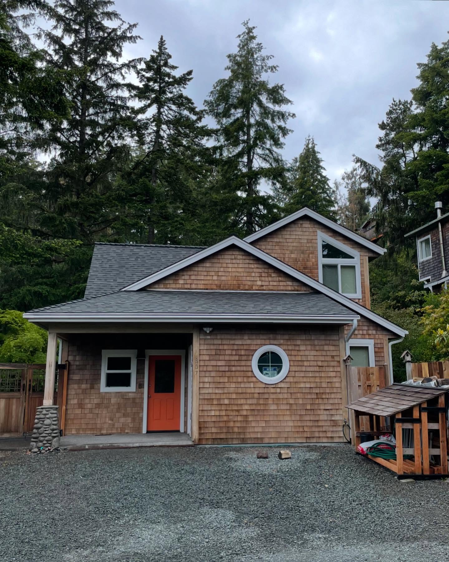 Cedar-shingle-sided home with a finished gray shingle roof