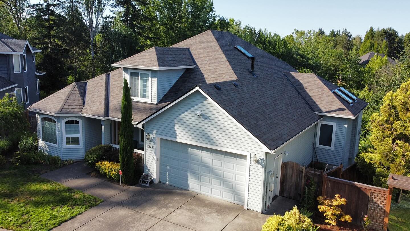 Aerial view of a finished roof replacement on a two-story home